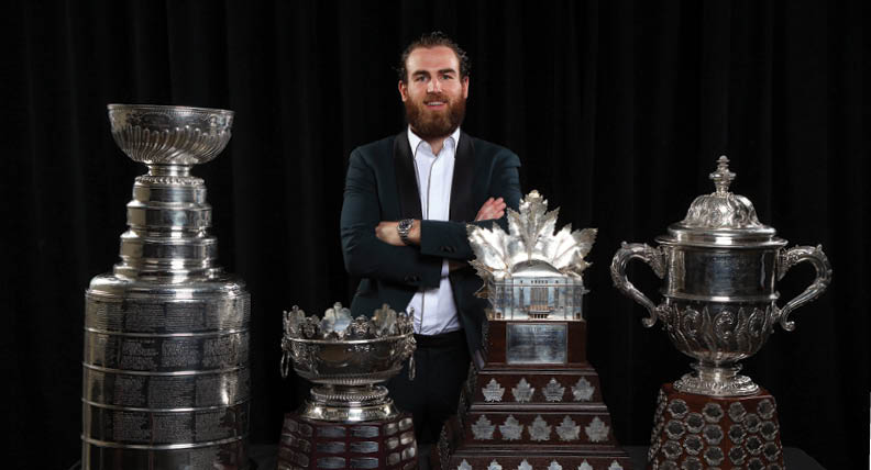 LAS VEGAS, NEVADA - JUNE 19: Ryan O'Reilly of the St  Louis Blues poses for a portrait with the Stanley Cup, Frank J  Selke Trophy, Conn Smythe Trophy and the Clarence S  Campbell Bowl during the 2019 NHL Awards at the Mandalay Bay Events Center on June 19, 2019 in Las Vegas, Nevada  (Photo by Andre Ringuette NHLI via Getty Images)
