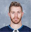 WINNIPEG, MB - SEPTEMBER 12: Bryan Little #18 of the Winnipeg Jets poses for his official headshot for the 2019-2020 season on September 12, 2019 at the Bell MTS Iceplex in Winnipeg, Manitoba, Canada   (Photo by Jonathan Kozub NHLI via Getty Images) *** Local Caption *** Bryan Little