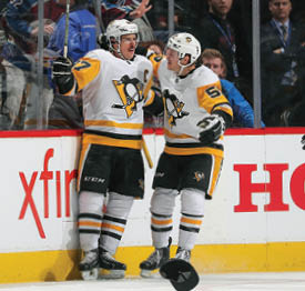 DENVER, CO - NOVEMBER 28: Sidney Crosby #87 of the Pittsburgh Penguins celebrates a hat trick against the Colorado Avalanche with teammate Jake Guentzel #59 at the Pepsi Center on November 28, 2018 in Denver, Colorado   (Photo by Michael Martin NHLI via Getty Images)