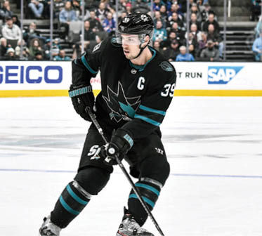 SAN JOSE, CA - DECEMBER 12: Logan Couture #39 of the San Jose Sharks skates ahead with the puck against the New York Rangers at SAP Center on December 12, 2019 in San Jose, California  (Photo by Brandon Magnus NHLI via Getty Images)