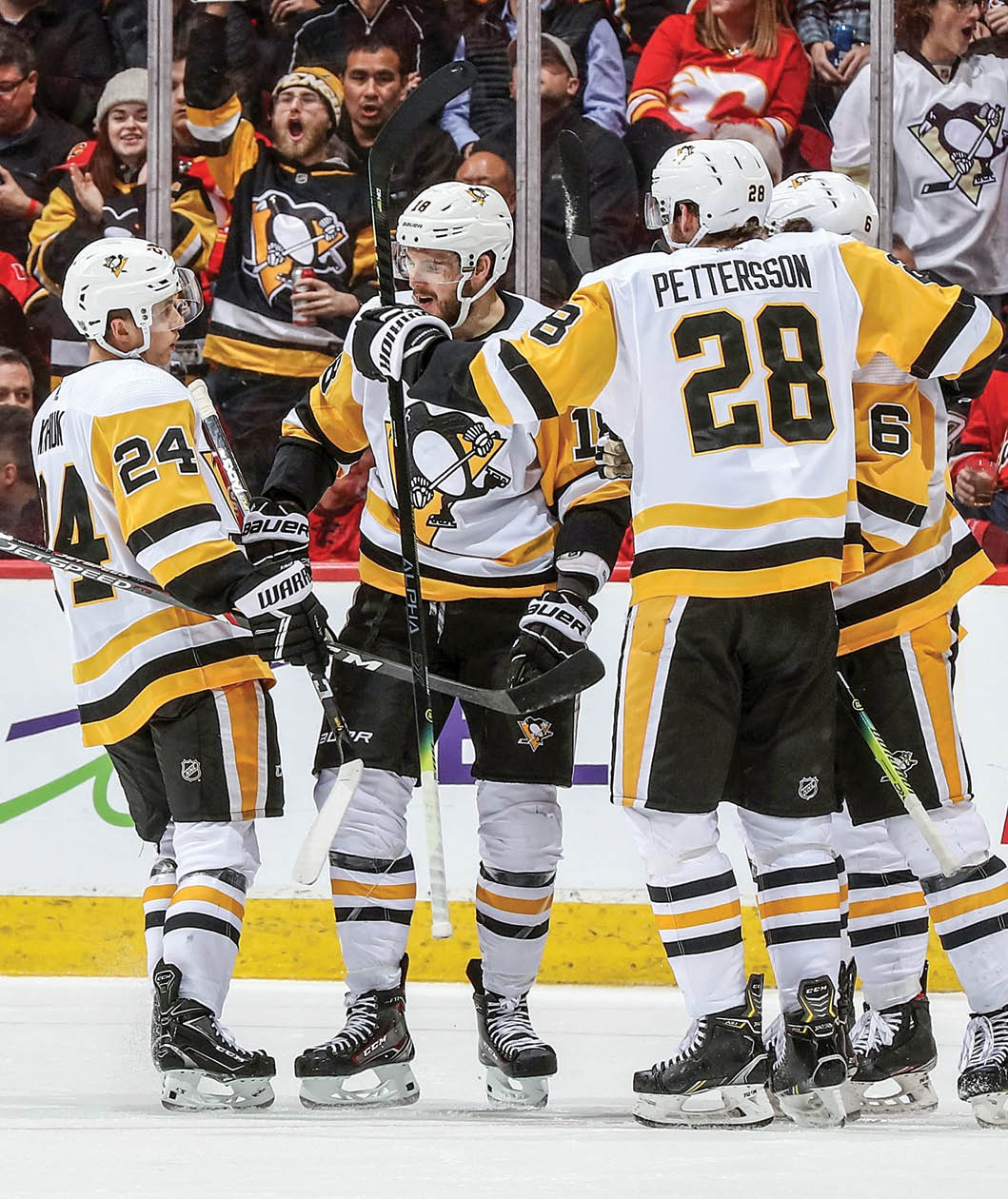 CALGARY, AB - DECEMBER 17: Alex Galchenyuk #18, Dominik Kahun #24, Marcus Pettersson #28 and John Marino #6 of the Pittsburgh Penguins celebrate a goal against the Calgary Flames on December 17, 2019 at the Scotiabank Saddledome in Calgary, Alberta, Canada  (Photo by Gerry Thomas NHLI via Getty Images)