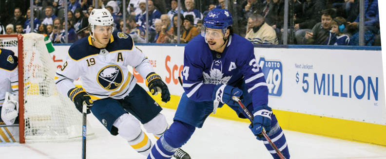 TORONTO, ON - DECEMBER 17: Toronto Maple Leafs center Auston Matthews (34) controls a puck as Buffalo Sabres defenseman Jake McCabe (19) tries to defend  during the first period in a game  between the Toronto Maple Leafs and the Buffalo Sabres on December 17, 2019, at Scotiabank Arena in Toronto, Ontario Canada  (Photo by Nick Turchiaro Icon Sportswire via Getty Images)