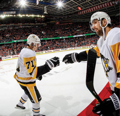 CALGARY, AB - DECEMBER 17: Evgeni Malkin #71 of the Pittsburgh Penguins celebrates a goal against the Calgary Flames with Zachary Aston-Reese #46 of the Pittsburgh Penguins and teammates during an NHL game on December 17, 2019 at the Scotiabank Saddledome in Calgary, Alberta, Canada  (Photo by Gerry Thomas NHLI via Getty Images)