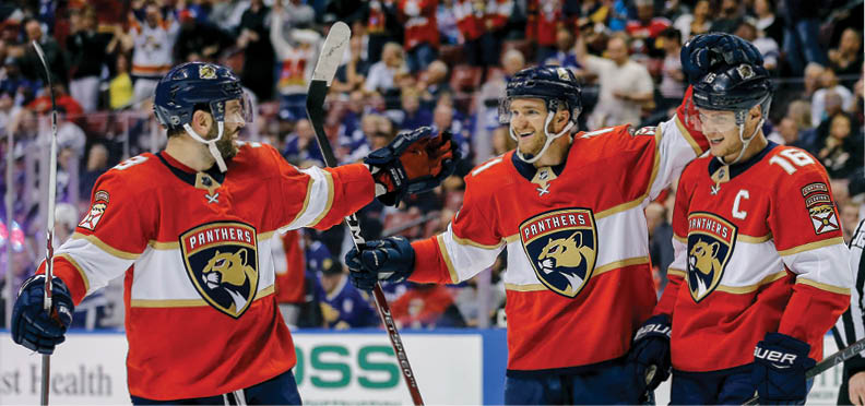 SUNRISE, FLORIDA - JANUARY 12:  Jonathan Huberdeau #11 of the Florida Panthers celebrates with teammates after assisting a goal which made him the the all-time Florida Panthers leader in points during the third period against the Toronto Maple Leafs at BB&T Center on January 12, 2020 in Sunrise, Florida  (Photo by Michael Reaves Getty Images)