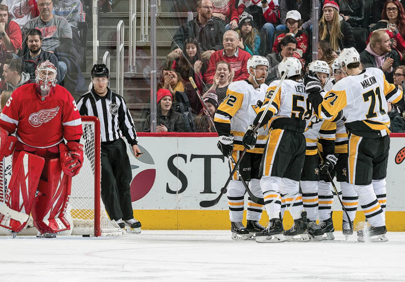 DETROIT, MI - JANUARY 17: Bryan Rust #17 of the Pittsburgh Penguins celebrates his third period goal with teammates Patric Hornqvist #72, Kris Letang #58, Sidney Crosby #87 and Evgeni Malkin #71 in front of goaltender Jimmy Howard #35 of the Detroit Red Wings during an NHL game at Little Caesars Arena on January 17, 2020 in Detroit, Michigan  (Photo by Dave Reginek NHLI via Getty Images)