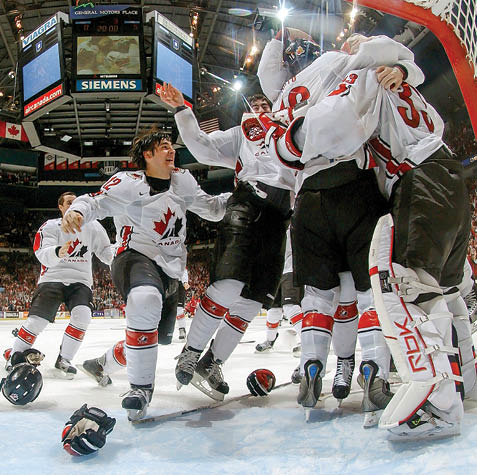 VANCOUVER, BRITISH COLUMBIA - JANUARY 5:  Kristopher Letang #12 of Team Canada and teammates crowd around goaltender Justin Pogge #33 after defeating Team Russia 5-0 in their World Junior Hockey Championship gold medal game at General Motors Place in Vancouver, Canada   (Photo by Dave Sandford Getty Images)