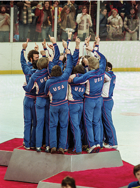 Members of the American Men's Olympic ice hockey team make the 'We're number one' gesture as they celebrate on the medal podium after receiving their gold medals, Lake Placid, New York, February 24, 1980  Team USA won the gold after defeating Finland but are best remembered for their victory over the Soviet team two days earlier, an event known as the 'Miracle on Ice ' Bronze-winning Swedes are seen at bottom right  (Photo by Robert Riger Getty Images)