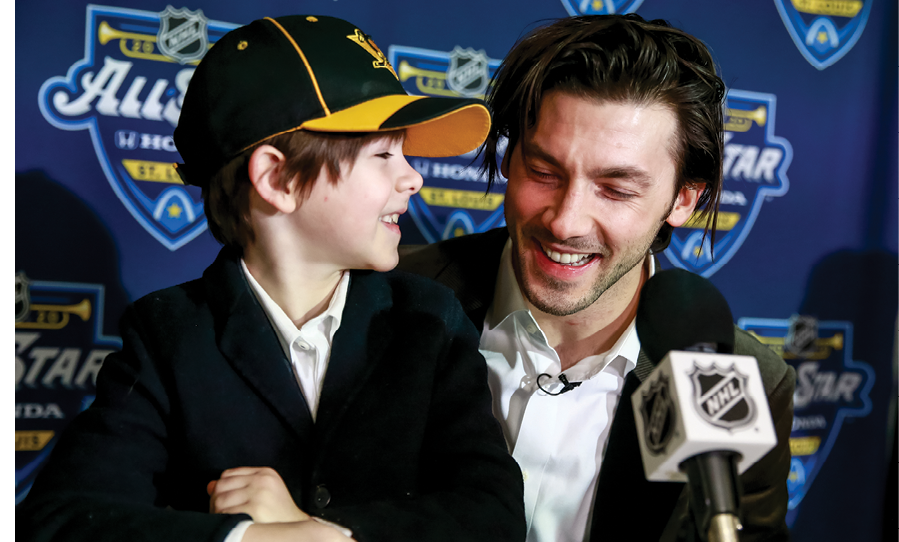 ST LOUIS, MISSOURI - JANUARY 24: Kris Letang #58 of the Pittsburgh Penguins and son Alexander speak to the media prior to participating in the 2020 NHL All-Star Skills competition at Enterprise Center on January 24, 2020 in St Louis, Missouri  (Photo by Jeff Vinnick NHLI via Getty Images)