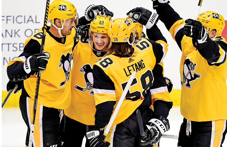 PITTSBURGH, PENNSYLVANIA - APRIL 25: The Pittsburgh Penguins celebrate a goal by Jake Guentzel #59 during a game between the Pittsburgh Penguins and Boston Bruins at PPG PAINTS Arena on April 25, 2021 in Pittsburgh, Pennsylvania  The Pittsburgh Penguins won 1-0  (Photo by Emilee Chinn Getty Images)