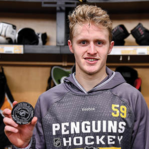 PITTSBURGH, PA - NOVEMBER 21:  Jake Guentzel #59 of the Pittsburgh Penguins poses with his first NHL goal puck after the game against the New York Rangers at PPG Paints Arena on November 21, 2016 in Pittsburgh, Pennsylvania   (Photo by Joe Sargent NHLI via Getty Images) 
