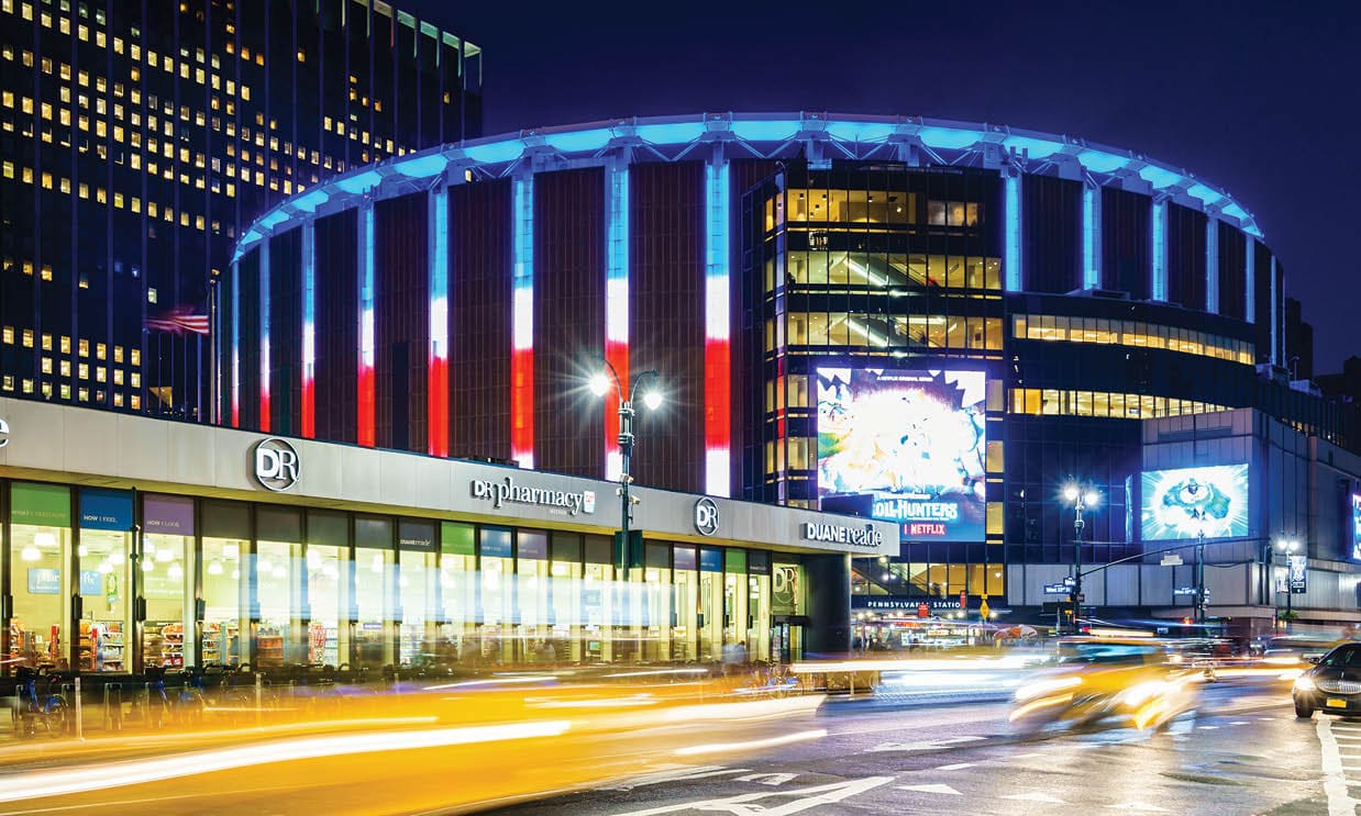 Madison Square Garden, New York, USA - 17 October, 2016: Illuminated stadium with car riding around 