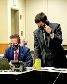 PITTSBURGH, PENNSLYVANIA- OCTOBER 07:  Hockey Operations Assistant Erik Heasley and Director of Hockey Research Sam Ventura of the Pittsburgh Penguins work at their draft table during rounds 2-7 of the 2020 NHL Entry Draft at PPG Paints Arena on October 07, 2020 in Pittsburgh, Pennsylvania  The 2020 NHL Draft was held virtually due to the ongoing Coronavirus pandemic  (Photo by Ryan Yorgen NHLI via Getty Images)