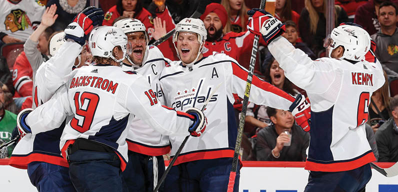 CHICAGO, IL - OCTOBER 20: Alex Ovechkin #8 of the Washington Capitals celebrates with teammates, including  John Carlson #74, after scoring against the Chicago Blackhawks in the third period at the United Center on October 20, 2019 in Chicago, Illinois   (Photo by Chase Agnello-Dean NHLI via Getty Images)