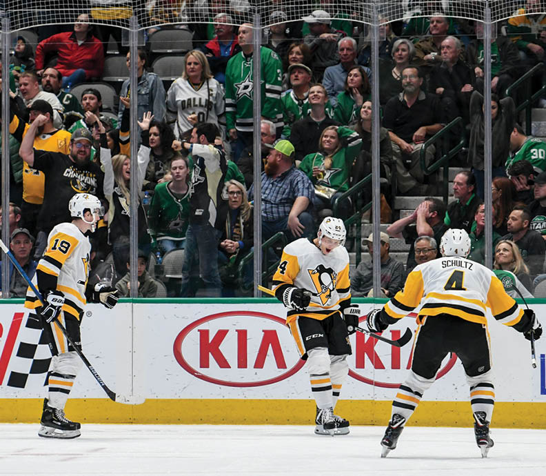 DALLAS, TX - OCTOBER 26: Dominik Kahun #24, Justin Schultz #4, Jared McCann #19 and the Pittsburgh Penguins celebrate a goal against the Dallas Stars at the American Airlines Center on October 26, 2019 in Dallas, Texas  (Photo by Glenn James NHLI via Getty Images)