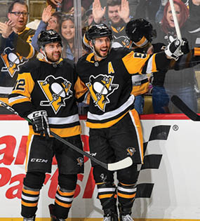 PITTSBURGH, PA - OCTOBER 18:  Kris Letang #58 celebrates his goal with Dominik Simon #12 of the Pittsburgh Penguins during the third period against the Dallas Stars at PPG PAINTS Arena on October 18, 2019 in Pittsburgh, Pennsylvania  (Photo by Joe Sargent NHLI via Getty Images)