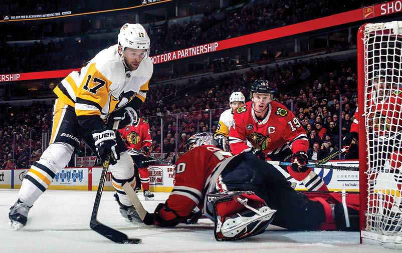CHICAGO, IL - DECEMBER 12:  Bryan Rust #17 of the Pittsburgh Penguins scores on goalie Corey Crawford #50 of the Chicago Blackhawks at the United Center on December 12, 2018 in Chicago, Illinois   (Photo by Chase Agnello-Dean NHLI via Getty Images)