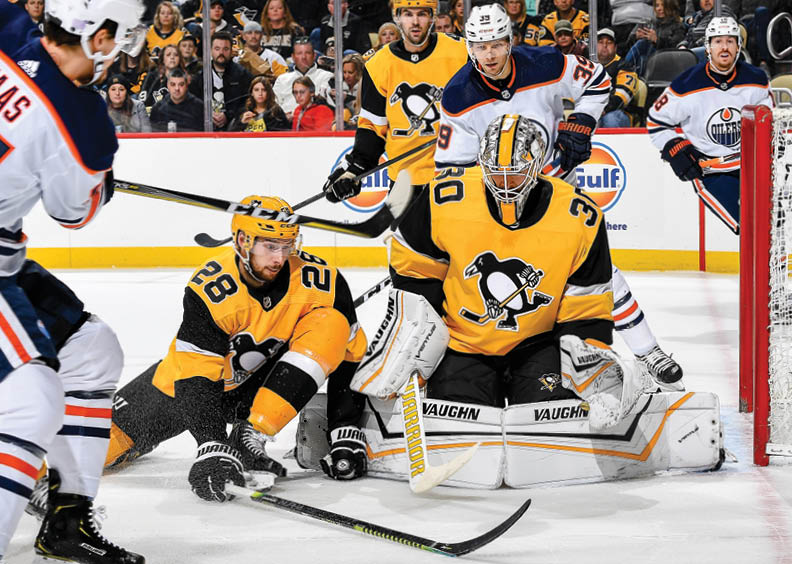 PITTSBURGH, PA - NOVEMBER 02:  Marcus Pettersson #28 and Matt Murray #30 of the Pittsburgh Penguins battle in front against the Edmonton Oilers at PPG PAINTS Arena on November 2, 2019 in Pittsburgh, Pennsylvania  (Photo by Joe Sargent NHLI via Getty Images)