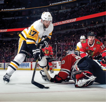 CHICAGO, IL - DECEMBER 12:  Bryan Rust #17 of the Pittsburgh Penguins scores on goalie Corey Crawford #50 of the Chicago Blackhawks at the United Center on December 12, 2018 in Chicago, Illinois   (Photo by Chase Agnello-Dean NHLI via Getty Images)