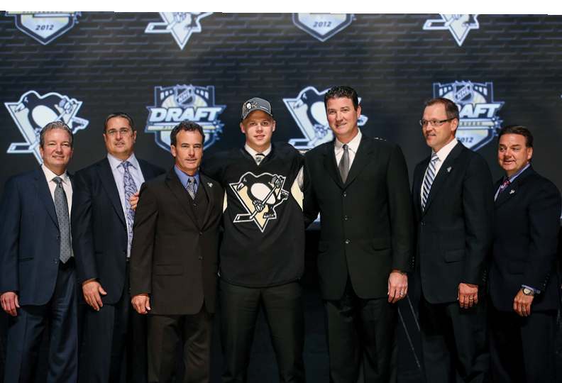 PITTSBURGH, PA - JUNE 22:  Olli Maatta (C), 22nd overall pick by the Pittsburgh Penguins, poses with Penguins co-owner Mario Lemieux (3rd R) and team representatives on stage during Round One of the 2012 NHL Entry Draft at Consol Energy Center on June 22, 2012 in Pittsburgh, Pennsylvania   (Photo by Bruce Bennett Getty Images)