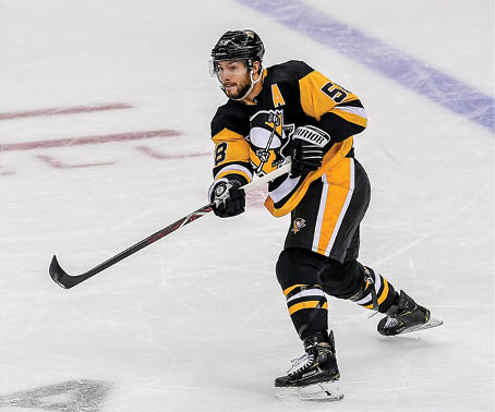 PITTSBURGH, PA - OCTOBER 08:Pittsburgh Penguins Defenceman Kris Letang (58) moves the puck during the second period in the NHL game between the Pittsburgh Penguins and the Winnipeg Jets on October 8, 2019, at PPG Paints Arena in Pittsburgh, PA  (Photo by Jeanine Leech Icon Sportswire via Getty Images)