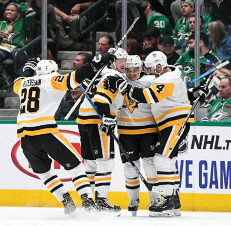 DALLAS, TX - OCTOBER 26: Dominik Kahun #24, Justin Schultz #4, Jared McCann #19 Marcus Pettersson #28 and the Pittsburgh Penguins celebrate a goal against the Dallas Stars at the American Airlines Center on October 26, 2019 in Dallas, Texas  (Photo by Glenn James NHLI via Getty Images)