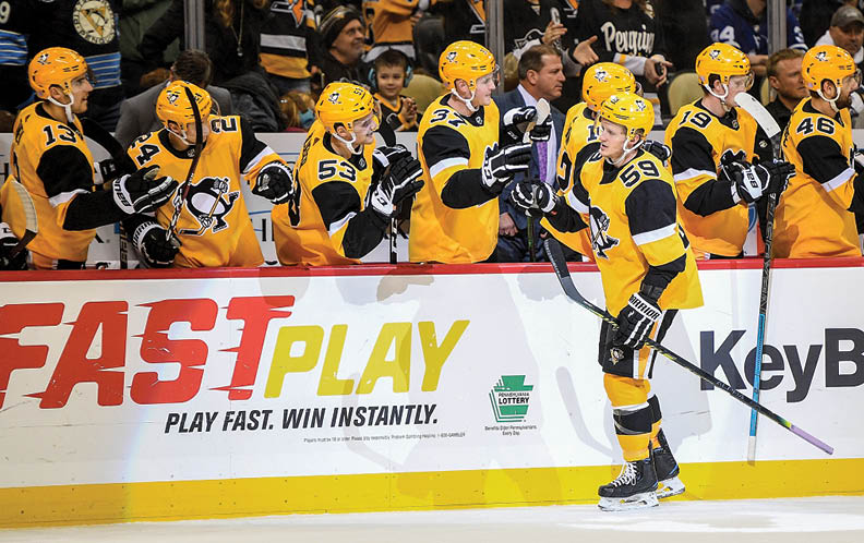 PITTSBURGH, PA - NOVEMBER 16: Jake Guentzel #59 of the Pittsburgh Penguins celebrates with teammates on the bench after scoring a goal in the first period during the game against the Toronto Maple Leafs at PPG Paints Arena on November 16, 2019 in Pittsburgh, Pennsylvania  (Photo by Justin Berl Icon Sportswire via Getty Images)