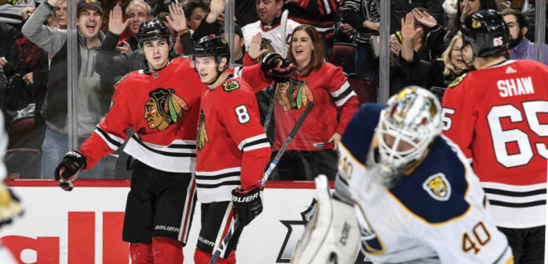 CHICAGO, IL - NOVEMBER 17: Kirby Dach #77 and Dominik Kubalik #8 of the Chicago Blackhawks celebrate after Dach scored against the Buffalo Sabres in the first period at the United Center on November 17, 2019 in Chicago, Illinois   (Photo by Bill Smith NHLI via Getty Images)