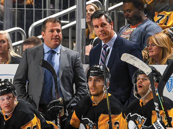 PITTSBURGH, PA - NOVEMBER 22:  Head coach Mike Sullivan of the Pittsburgh Penguins talks with assistant coach Mark Recchi during the game against the New Jersey Devils at PPG PAINTS Arena on November 22, 2019 in Pittsburgh, Pennsylvania  (Photo by Joe Sargent NHLI via Getty Images)