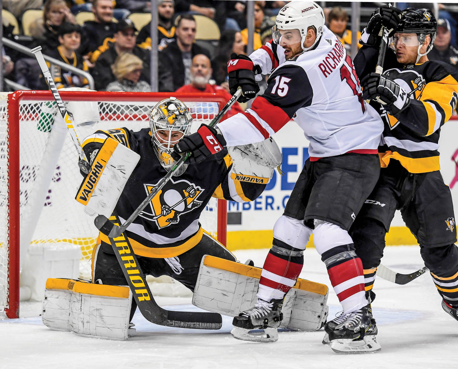 PITTSBURGH, PA - DECEMBER 06: Pittsburgh Penguins Goalie Tristan Jarry (35) makes a save on Arizona Coyotes Center Brad Richardson (15) in front wheel Pittsburgh Penguins Defenseman Chad Ruhwedel (2) defends during the first period in the NHL game between the Pittsburgh Penguins and the Arizona Coyotes on December 6, 2019, at PPG Paints Arena in Pittsburgh, PA  (Photo by Jeanine Leech Icon Sportswire via Getty Images)