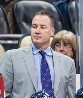 December 30 2014: Robert Morris Colonials Head Coach Derek Schooley (Left) watches the play from behind the bench during the first period of the NCAA Hockey game between Colgate Raiders and Robert Morris Colonials at the Consol Energy Center in Pittsburgh, Pennsylvania (Photo by Justin Berl Icon Sportswire Corbis Icon Sportswire via Getty Images)